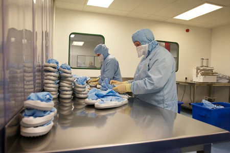 Cleanroom boots are folded prior to being packaged and autoclaved