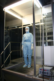 Figure 3: Test subject in standing simulation with cleanroom coverall, hood, boots and suitable equipment